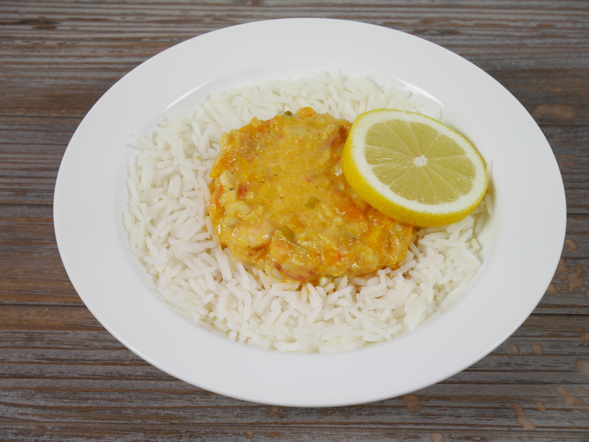Fischragout mit Garnelen und Krbis im
              Reisrand